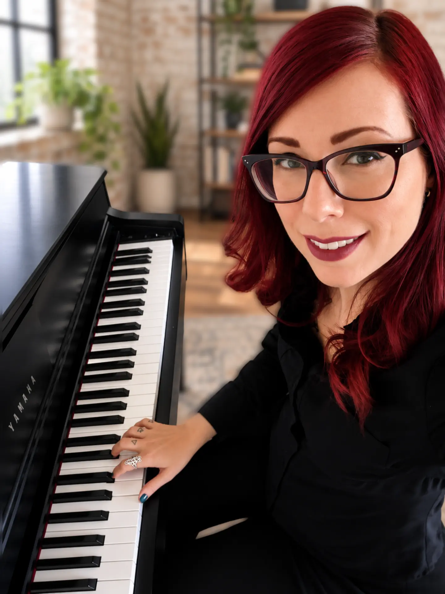 Phoenix, creator of Piano Skill Set, at the piano in her studio